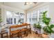 Sunny breakfast nook with bench seating, wood table, and large windows overlooking the backyard at 5943 Charing Pl, Charlotte, NC 28211