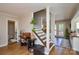 Inviting entryway featuring hardwood floors, a staircase, and views into other living spaces at 5943 Charing Pl, Charlotte, NC 28211