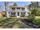 Charming two-story white brick home featuring a double front porch and well-maintained landscaping at 5943 Charing Pl, Charlotte, NC 28211