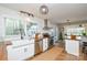 Well-lit kitchen showcasing white cabinetry, a stainless steel hood, and butcher block countertops at 5943 Charing Pl, Charlotte, NC 28211