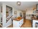 Bright kitchen with white cabinets, a wood-topped island, stainless steel appliances, and hardwood floors at 5943 Charing Pl, Charlotte, NC 28211