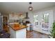 Open kitchen featuring white cabinets, butcher block countertops, and a view to the outdoor deck at 5943 Charing Pl, Charlotte, NC 28211