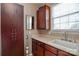 Well-equipped laundry room with ample storage cabinets, a sink, and natural light from a large window at 5943 Charing Pl, Charlotte, NC 28211