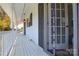 A porch featuring white pillars and a door with the screen door slightly open at 5943 Charing Pl, Charlotte, NC 28211