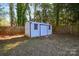 Exterior shot of backyard shed, perfect for extra storage, nestled in a treed yard at 5943 Charing Pl, Charlotte, NC 28211