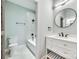 Elegant bathroom with a modern vanity, round mirror, and a tiled shower-tub combination at 7 Private St, York, SC 29745