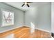 Sunny bedroom featuring hardwood floors and a large window bringing in natural light and warmth at 7 Private St, York, SC 29745