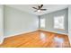 Bright bedroom with hardwood floors, ceiling fan, and two windows allowing natural light at 7 Private St, York, SC 29745