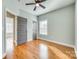 This bedroom has wood flooring, a ceiling fan, and multiple windows for plenty of natural light at 7 Private St, York, SC 29745