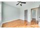 Comfortable bedroom with hardwood floors, a ceiling fan, and a doorway to an adjacent room at 7 Private St, York, SC 29745