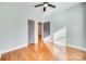 Inviting bedroom featuring hardwood floors, a ceiling fan, and dual doorways for accessibility at 7 Private St, York, SC 29745