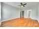 Spacious bedroom with hardwood floors, a ceiling fan, and access to a bathroom at 7 Private St, York, SC 29745