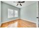 Cozy bedroom with hardwood floors, ceiling fan, and a bright window showcasing natural light at 7 Private St, York, SC 29745