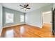 Well-lit bedroom featuring hardwood floors, a ceiling fan, and an adjacent doorway at 7 Private St, York, SC 29745