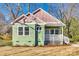 Charming green home with a covered front porch and unique pink accents at 7 Private St, York, SC 29745