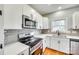 Well-equipped kitchen with stainless steel appliances, quartz counters, and subway tile backsplash at 7 Private St, York, SC 29745