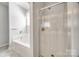 Bathroom showcasing a shower stall and a corner tub with neutral wall colors at 7124 Bevington Woods Ln, Charlotte, NC 28277