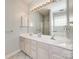 Bathroom featuring a double sink vanity with large mirror and neutral colors at 7124 Bevington Woods Ln, Charlotte, NC 28277