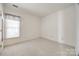 Bedroom featuring neutral walls, carpet floor, and bright window at 7124 Bevington Woods Ln, Charlotte, NC 28277