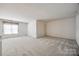 Spacious bonus room with neutral carpeting and natural light from a window at 7124 Bevington Woods Ln, Charlotte, NC 28277