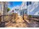 Wooden deck with white siding and a sunroom, leading to a lush yard at 7124 Bevington Woods Ln, Charlotte, NC 28277