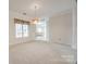 Dining area with carpet flooring and natural light at 7124 Bevington Woods Ln, Charlotte, NC 28277