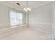 Dining area featuring white tile floor, large bright window, and hanging light fixture at 7124 Bevington Woods Ln, Charlotte, NC 28277