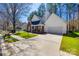 Charming single-Gathering home featuring a brick facade, attached garage, and well-maintained front yard at 7124 Bevington Woods Ln, Charlotte, NC 28277