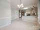 Eat-in kitchen leading into dining area and features white tile floors at 7124 Bevington Woods Ln, Charlotte, NC 28277