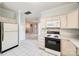 A view of the kitchen and cooktop stove, with a view to living room at 7124 Bevington Woods Ln, Charlotte, NC 28277