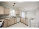 Functional kitchen with light wood cabinets and white appliances at 7124 Bevington Woods Ln, Charlotte, NC 28277