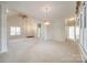 Large living room with lots of space, multiple doorways, and bright light at 7124 Bevington Woods Ln, Charlotte, NC 28277