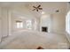 Spacious living room with vaulted ceiling, fireplace, and lots of natural light at 7124 Bevington Woods Ln, Charlotte, NC 28277