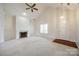 Bright living room with high ceilings, fireplace, and neutral carpet at 7124 Bevington Woods Ln, Charlotte, NC 28277