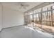 Sunroom with ceiling fan and sliding glass doors leading to an outdoor deck at 7124 Bevington Woods Ln, Charlotte, NC 28277