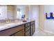 Bathroom showcasing a double vanity with granite counters, framed mirror, and decorative towel arrangement at 7645 Bainbridge Rd, Sherrills Ford, NC 28673