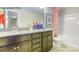 Bathroom featuring a granite vanity, framed mirror, tub, and decorative accents at 7645 Bainbridge Rd, Sherrills Ford, NC 28673