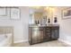 Bathroom featuring double vanity, granite counters, and an oversized tub for relaxing at 7645 Bainbridge Rd, Sherrills Ford, NC 28673