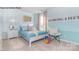 Bedroom with light blue walls, a white chair, and bright, natural light from large windows at 7645 Bainbridge Rd, Sherrills Ford, NC 28673