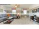 Comfortable living room featuring a gray sofa, accent wall, plush carpet, and a modern ceiling fan at 7645 Bainbridge Rd, Sherrills Ford, NC 28673