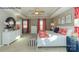 This bright main bedroom features a tray ceiling, soft carpet, and red patterned accents at 7645 Bainbridge Rd, Sherrills Ford, NC 28673