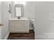 Bathroom showcasing vanity with white countertops and dark wood floors at 792 N Davidson St, Charlotte, NC 28202