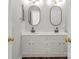 Bathroom featuring double sinks with black fixtures, modern lighting, and white cabinets at 792 N Davidson St, Charlotte, NC 28202