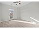 Bedroom featuring a ceiling fan, a picture window, and neutral color carpet at 792 N Davidson St, Charlotte, NC 28202