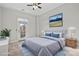 Staged bedroom featuring a ceiling fan, a picture window, and a large bed with blue accents at 792 N Davidson St, Charlotte, NC 28202