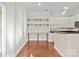 Home office and kitchen area with white cabinetry and hardwood floors at 792 N Davidson St, Charlotte, NC 28202