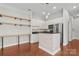 Well-appointed kitchen with white cabinetry, granite countertops, and functional island with breakfast bar at 792 N Davidson St, Charlotte, NC 28202