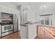 Open kitchen featuring stainless steel appliances, island, and seamless flow into the living space at 792 N Davidson St, Charlotte, NC 28202