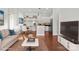 Staged living room and dining area with hardwood floors and stainless steel appliances at 792 N Davidson St, Charlotte, NC 28202