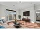 Staged living room with hardwood floors, a balcony, and access to the bathroom at 792 N Davidson St, Charlotte, NC 28202